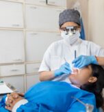 Indian,Dentist,Cleaning,The,Mouth,Of,A,Patient,With,Accurate