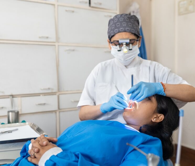 Indian,Dentist,Cleaning,The,Mouth,Of,A,Patient,With,Accurate